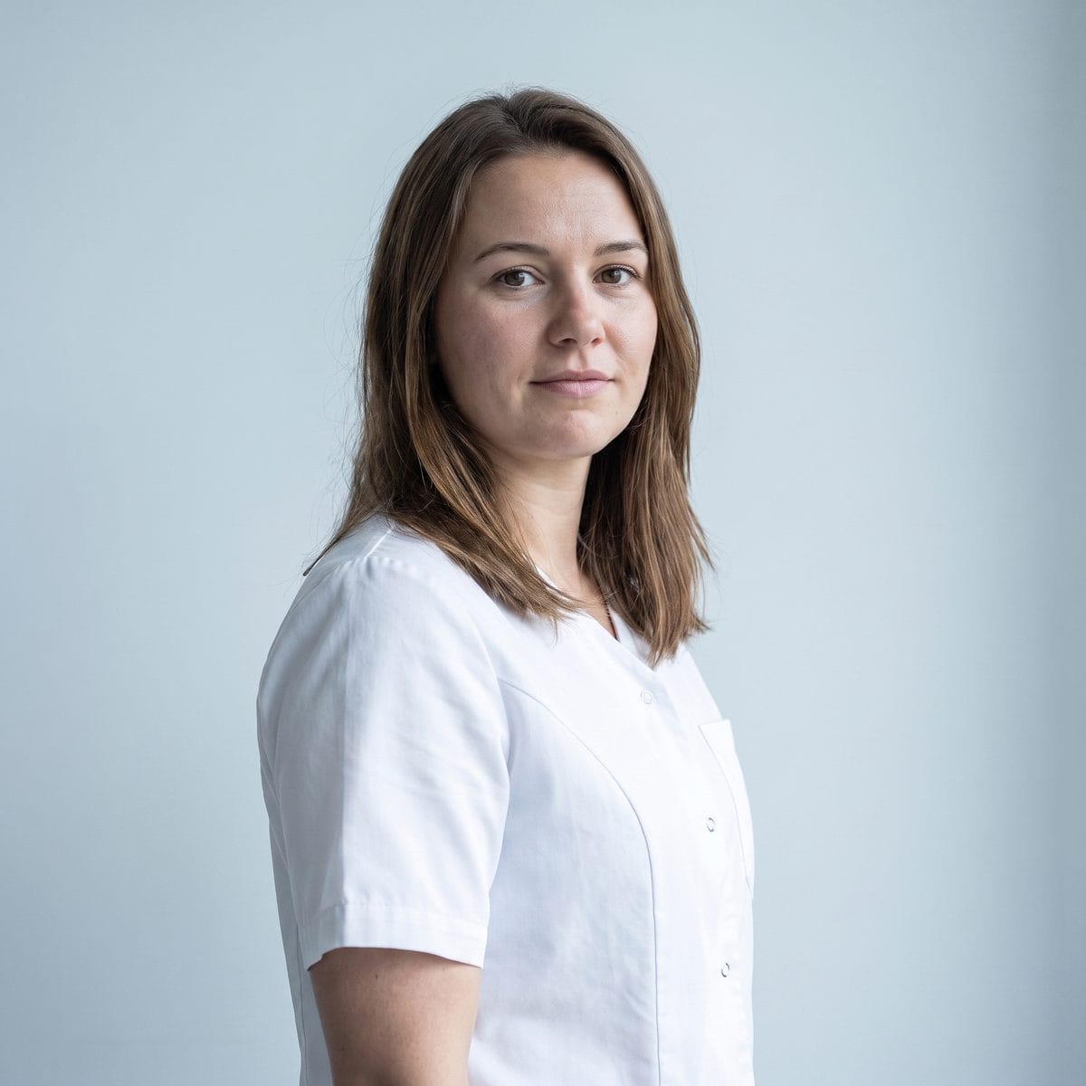 Portrait of one of the practice's medical aestheticians against a plain pale background.